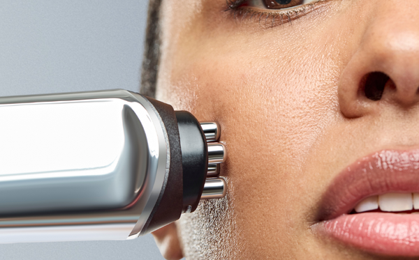 Woman experiencing at home RF treatment on her face 