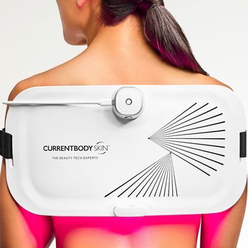 Woman with the LED Light Therapy Panel on her back